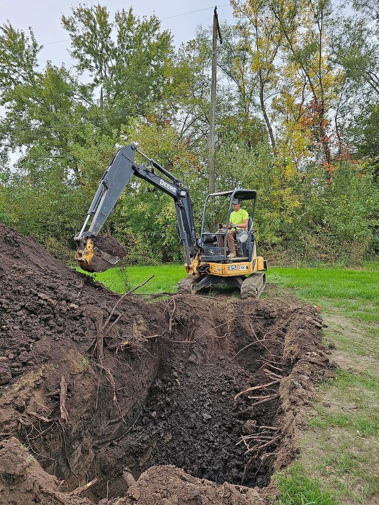 John Deere 35D excavator digging a septic trench
