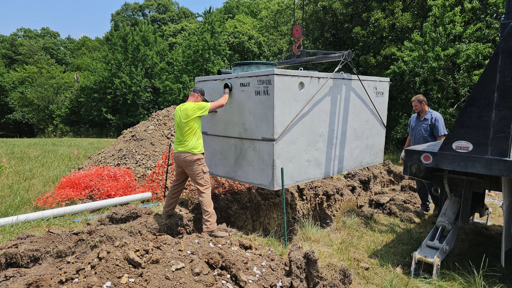 Burns Septic crew setting a 1250 gallon concrete septic tank